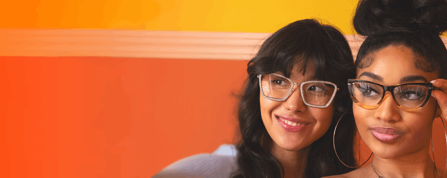 Two beautiful young women wear stylish photo-gradient sunglasses, both in a retro cat-eye shape.