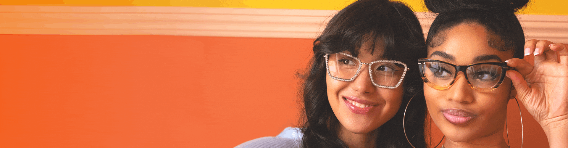 Two beautiful young women wear stylish photo-gradient sunglasses, both in a retro cat-eye shape.